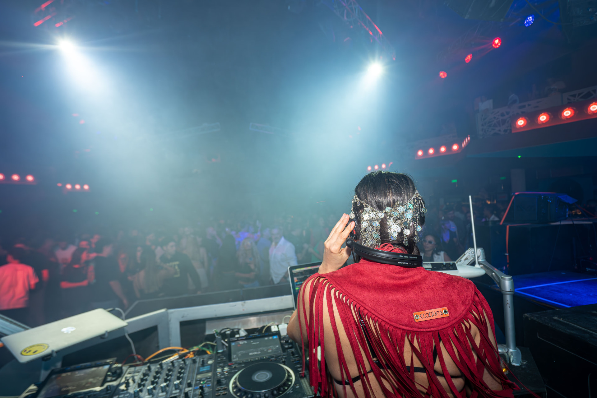 DJ performing for the crowd under blue and red lights at Chameleon Club Dubai