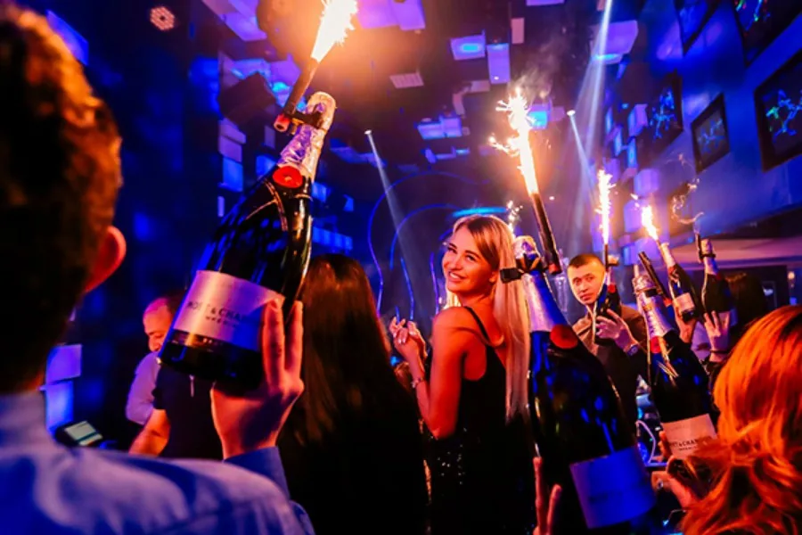 Guests celebrating with sparkler bottle service at Chameleon Club Dubai