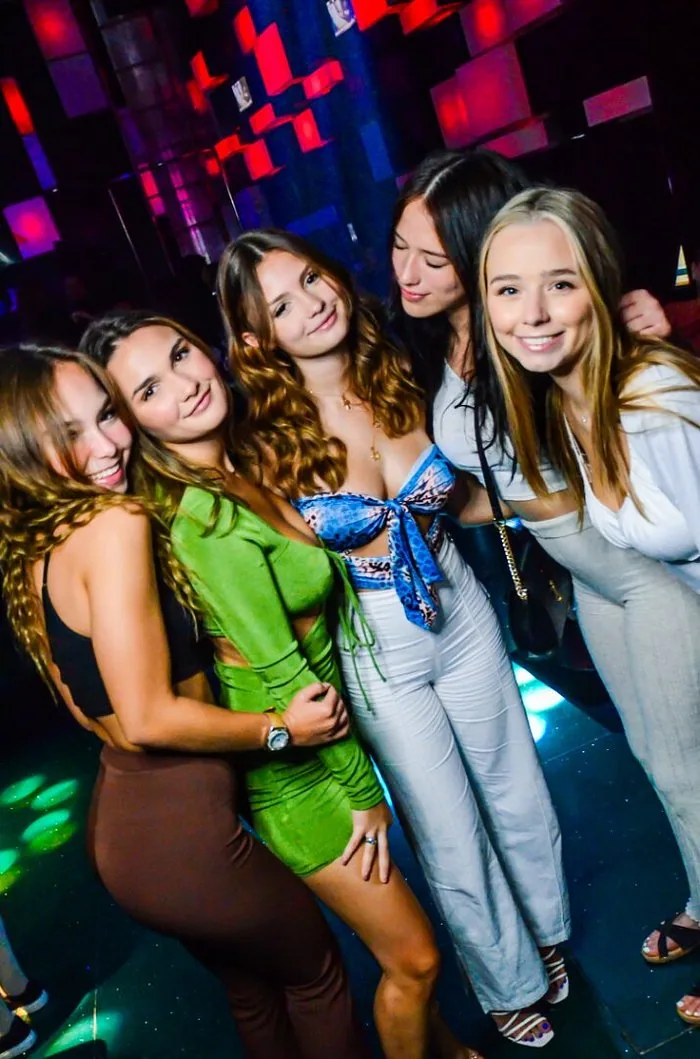 Five friends posing together on a night out at Chameleon Club Dubai