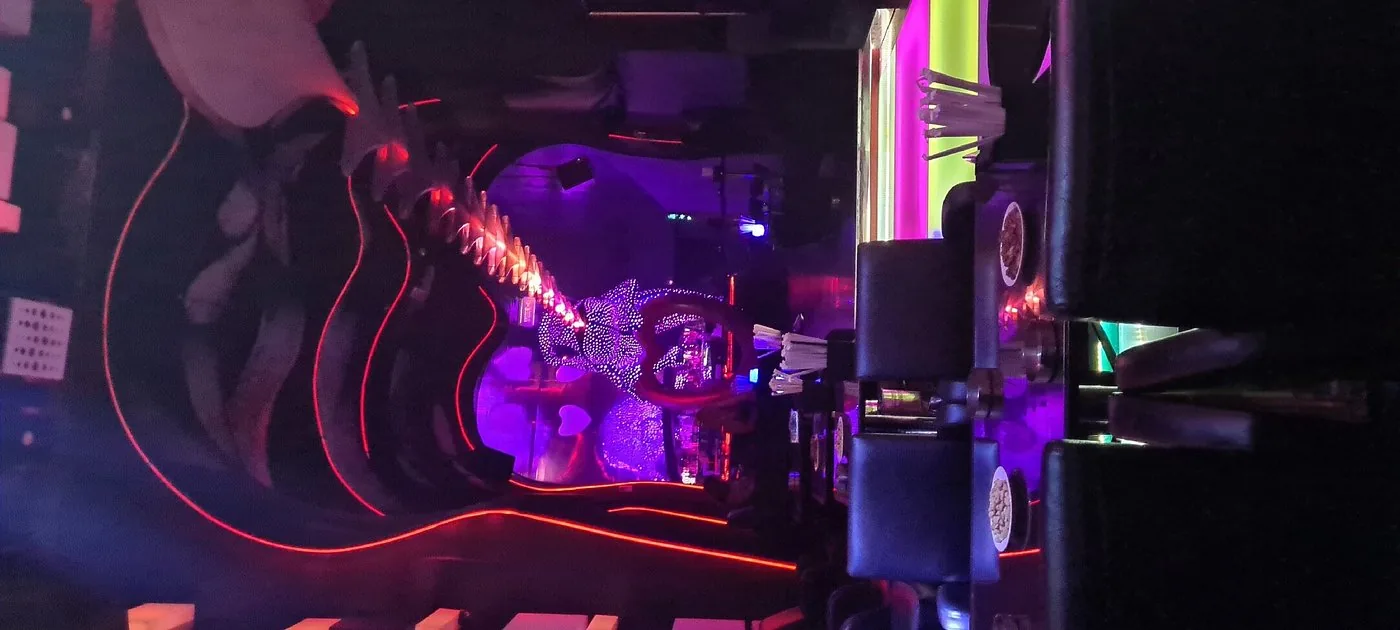 Main stage DJ booth glowing violet and red at Chameleon Club Dubai