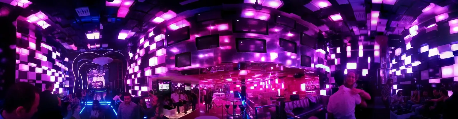 Panoramic view of Chameleon Club Dubai's main room with glowing magenta LED cube walls