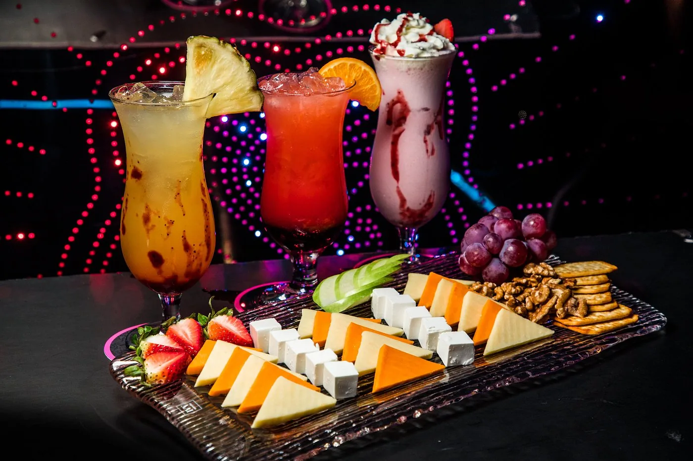 Cheese platter with tropical drinks and a shake