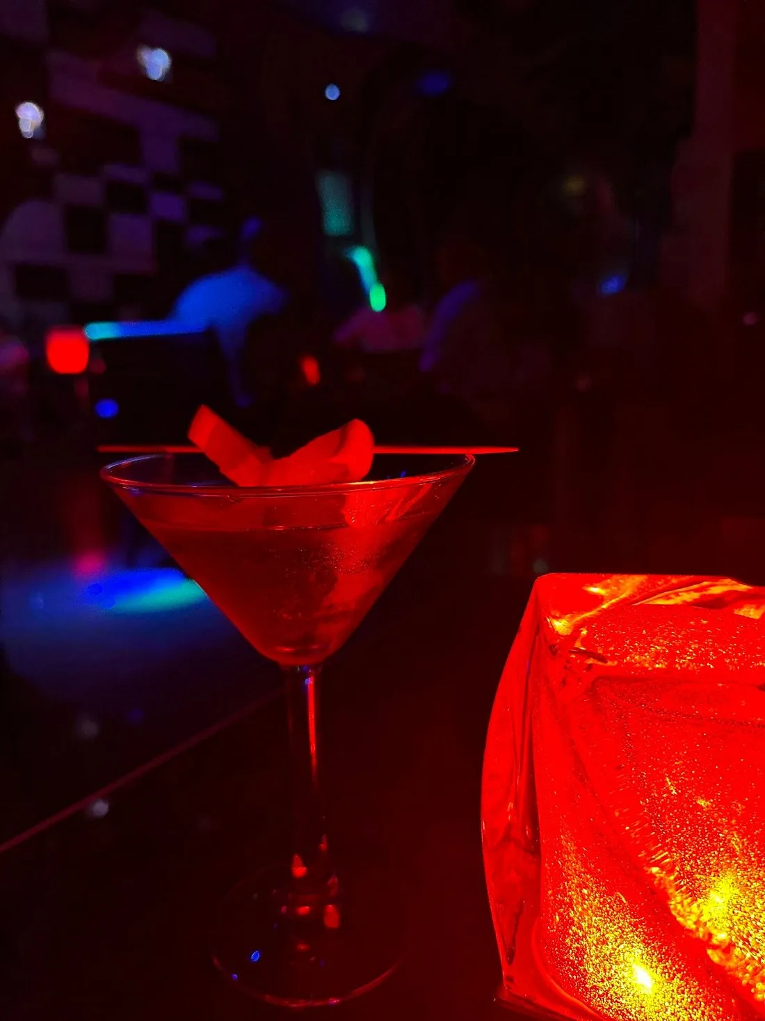 Red martini-style cocktail in dramatic red light