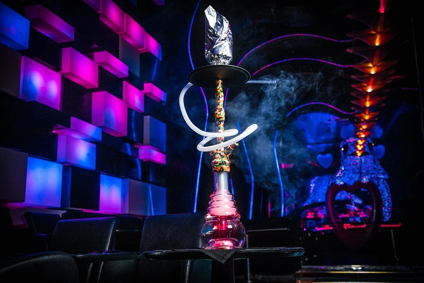 Shisha in the lounge beside glowing LED walls