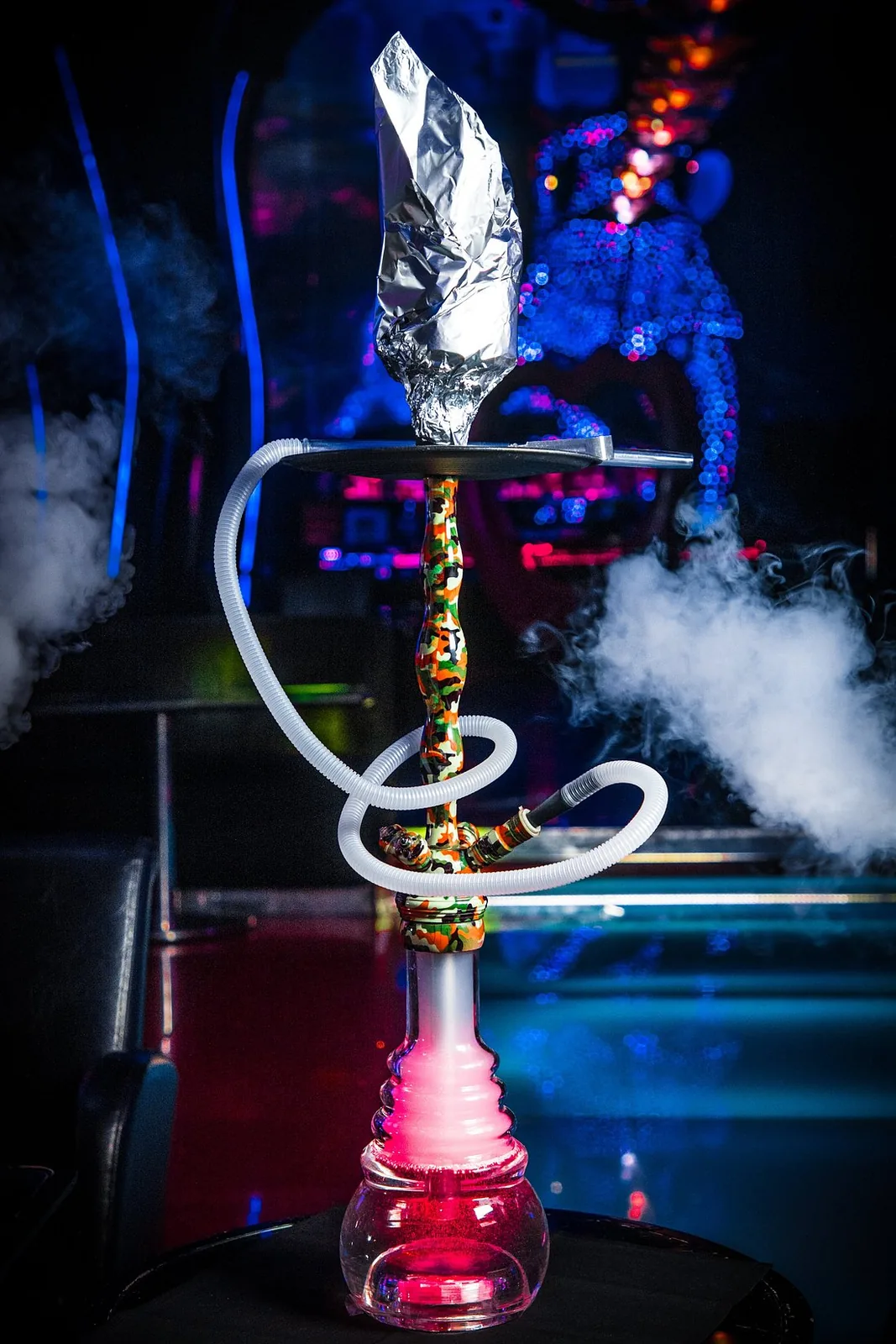 Signature shisha with smoke under blue and pink lights
